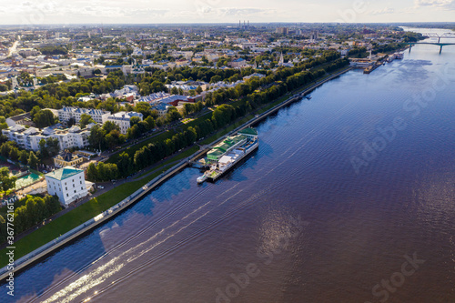 a large city with churches from the embankment along the river filmed from a drone