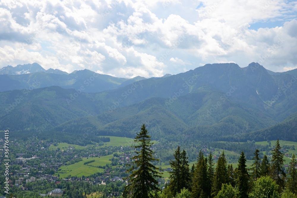 Mountain summer view. Zakopane city seen from Gubalowka Mountain, Poland, Europe. Gubalowka mountain is a popular tourist attraction, offering views of the Tatra Mountains and Zakopane. Mountain summer view. Zakopane city seen from Gubalowka Mountain, Poland, Europe. Gubalowka mountain is a popular tourist attraction, offering views of the Tatra Mountains and Zakopane.