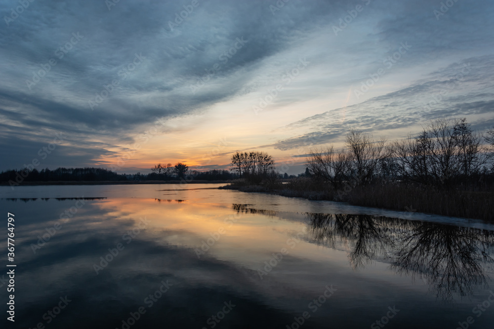 Fantastic reflection of the clouds in the lake at sunset Fantastic reflection of the clouds in the lake at sunset