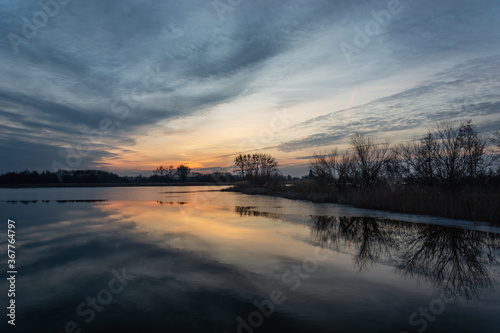 Fantastic reflection of the clouds in the lake at sunset