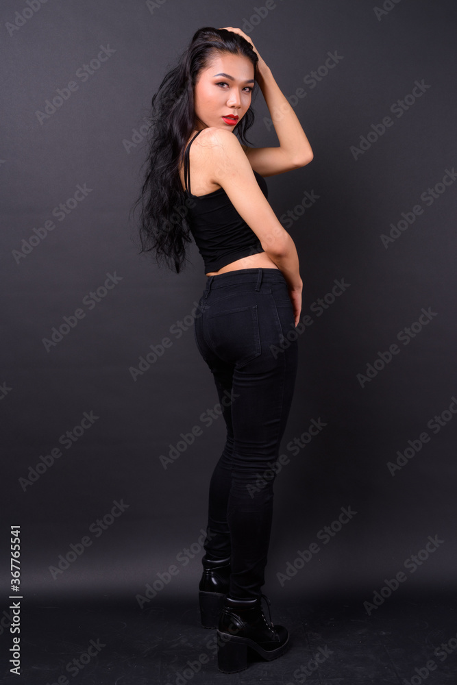 Young beautiful Asian transgender woman against black background Young beautiful Asian transgender woman against black background