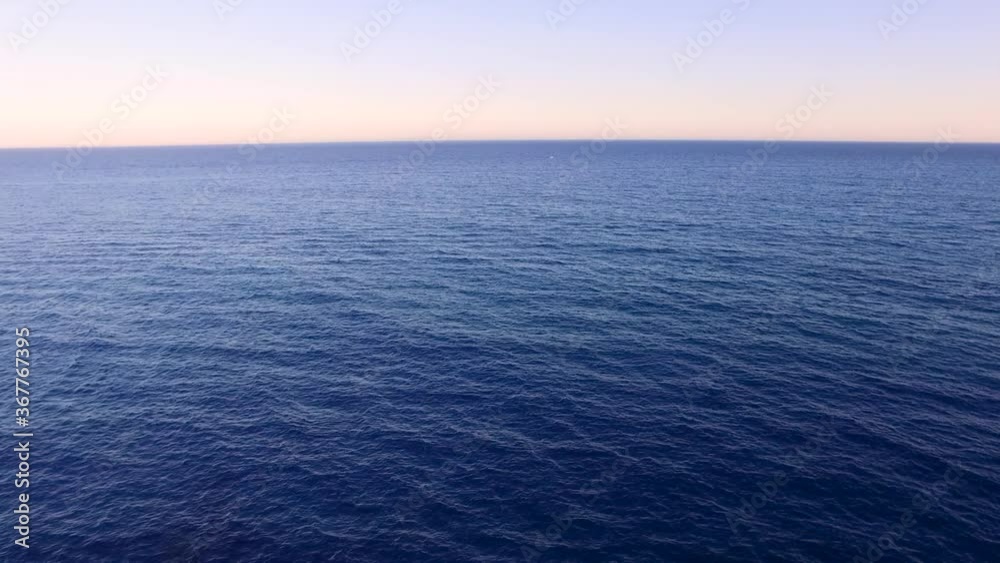 Sunset sea aerial view. Drone shot above ocean. Sea horizon. Mediterranean sea, paradise, tropical exotic sea. Moving towards the skyline. Sunset sea aerial view. Drone shot above ocean. Sea horizon. Mediterranean sea, paradise, tropical exotic sea. Moving towards the skyline.
