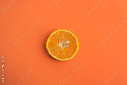 An orange slice on an orange surface