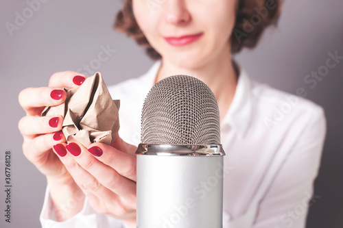 Unrecognisable girl is about to do ASMR sounds with crumpled paper. Trigger for stress and anxiety attack relief, good sleep.