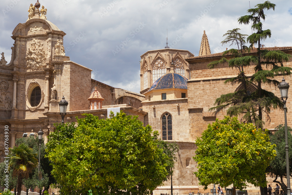 Metropolitan Basilica Cathedral of Saint Mary in Valencia with the bell tower El Miquelete. Plaza de la Reina. Spain.