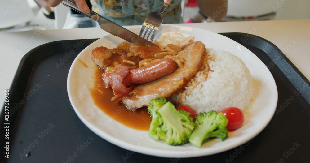 Woman eat at fast food restaurant