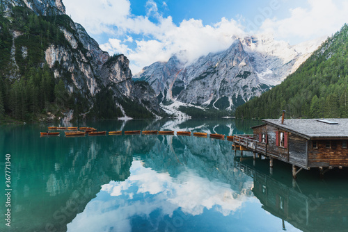 Picturesque view on boathouse at beautiful mountain lake Lago di braies (Pragser Wildsee) with wooden boats in the Dolomites,Italy
