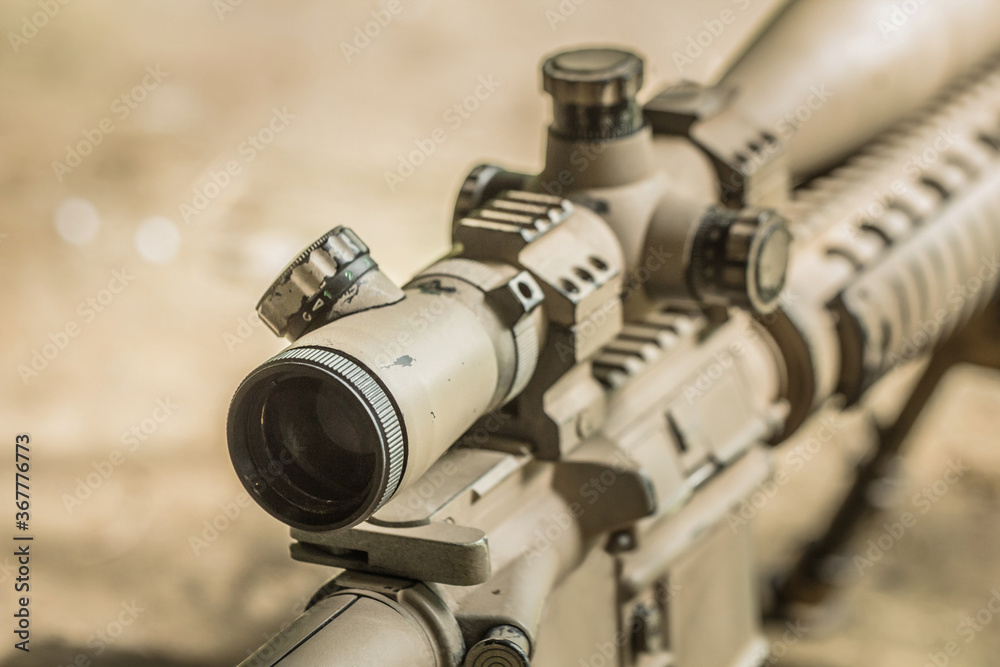 High military grade precising rifle scope lens in tan surface color attach on ar marksmanship rifle  