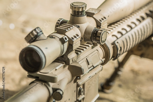 High military grade precising rifle scope lens in tan surface color attach on ar marksmanship rifle  