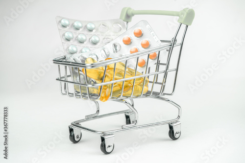 omega 3 fish oil big gel capsules, pills in a shopping cart, pharmacy, drugs selling concept, healthcare, vitamins