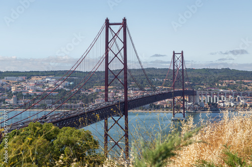 Bridge on April 25 in Lisbon on the Tejo river with moving cars.