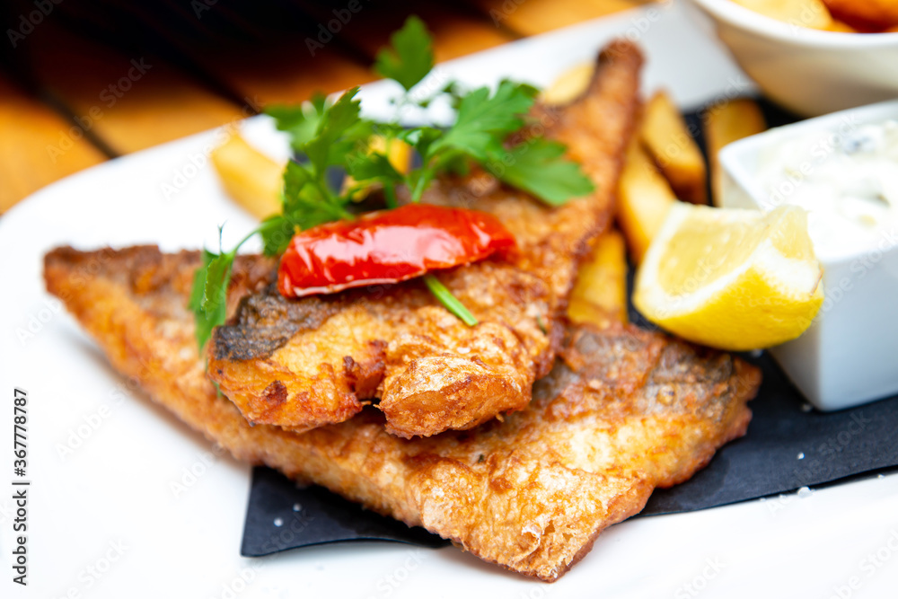 British Traditional fish and chips and tartar sauce British Traditional fish and chips and tartar sauce
