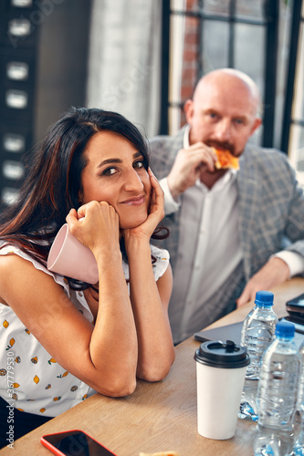 Happy business team eating pizza in office.Business food  lunch and people concept.