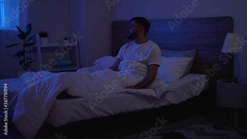 Male sleepwalker in bedroom at night
