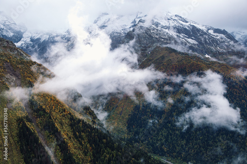 Fog in the mountains  scenic view from the Mount Mussa Achitara in Dombay ski resort in autumn season  Caucasus  Russia