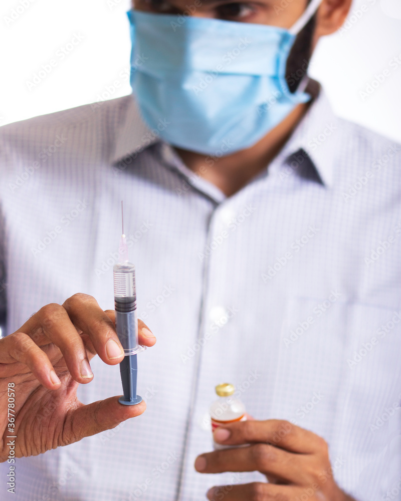 Doctor with vaccine and syringe Doctor with vaccine and syringe