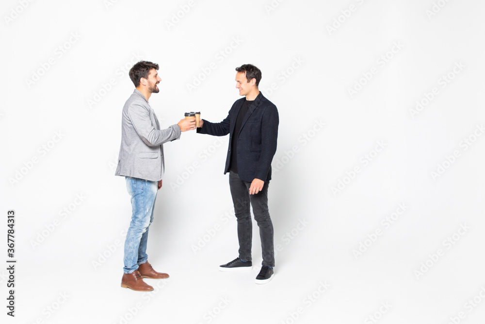 Young two men corporate executives standing and talking with coffee, isolated on white background. Young two men corporate executives standing and talking with coffee, isolated on white background.