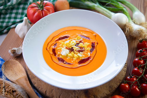 Traditional spanish Salmorejo. Cold tomato soup made with garlic, tomatoes, onion, bread and served with olive oil, iberico ham and boiled egg.