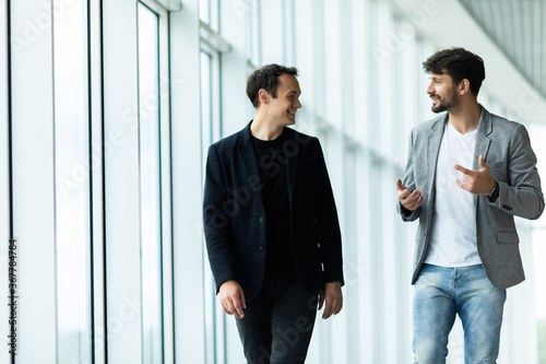 Obraz na plátně Portrait of two concentrated businessmen partners dressed in formal suit walking