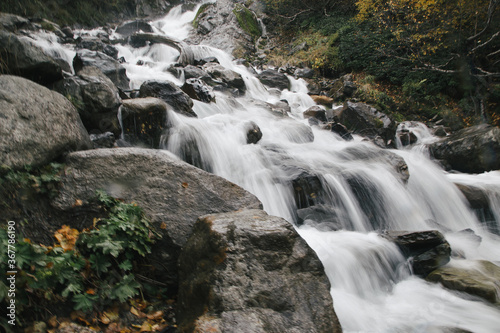 Stream of water of the mountains river  big stones  long exposure