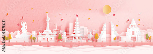Autumn in Denpasar, Bali. Indonesia with falling maple leaves and world famous landmarks in paper cut style vector illustration