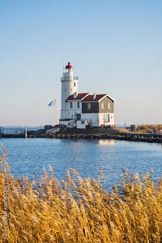 View of Paard van Marken lighthouse, Netherlands, Waterland district near Amsterdam, popular travel destination and tourist attraction. Autumn, fall concept