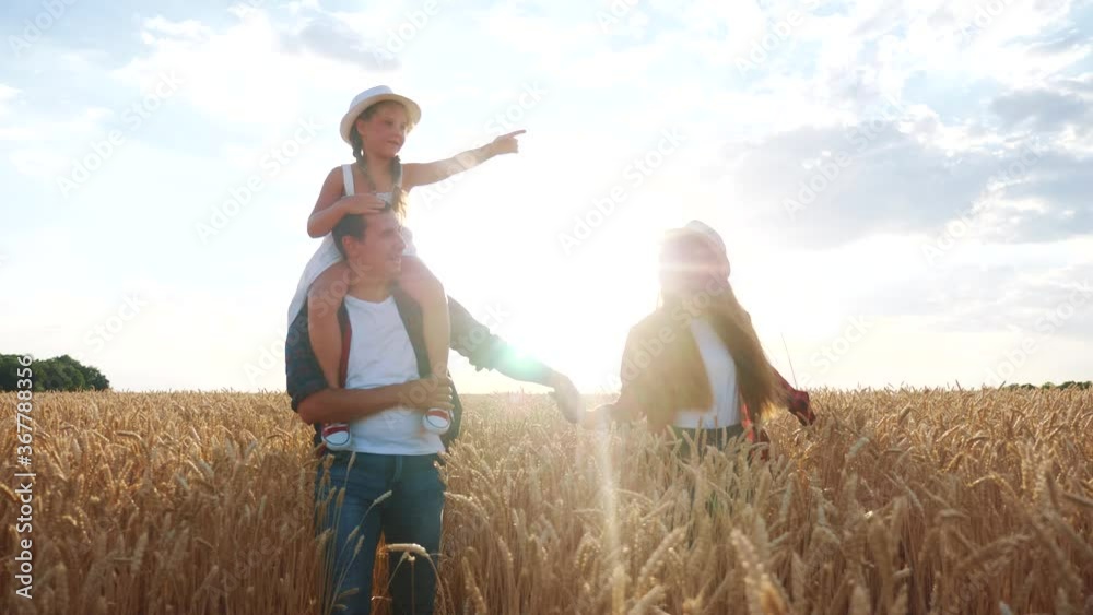 happy family fun walk at sunset in the field with wheat. mom dad and girl kid daughter walk outdoor in the park sunset silhouette lifestyle. happy childhood dream family concept. parents and child happy family fun walk at sunset in the field with wheat. mom dad and girl kid daughter walk outdoor in the park sunset silhouette lifestyle. happy childhood dream family concept. parents and child