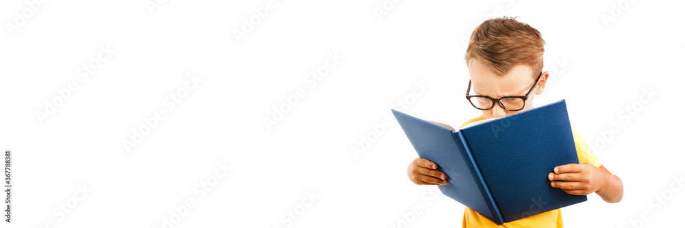child reads a book against a bright wall child reads a book against a bright wall