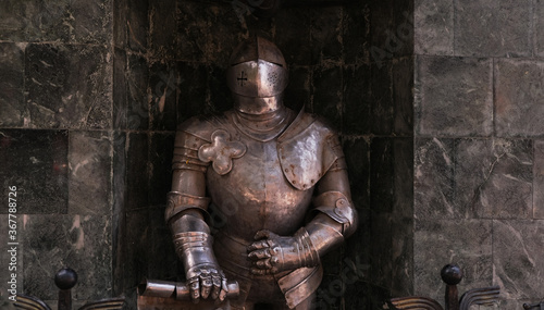 iron armor of a knight by a stone wall
