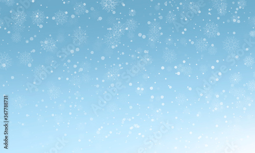 winter light blue background with snowflakes and bokeh effect. Christmas card.