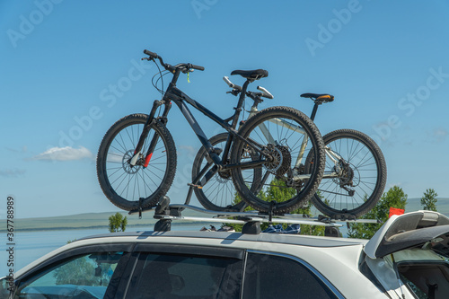 bicycles are attached to the trunk of the car. concept of active recreation.