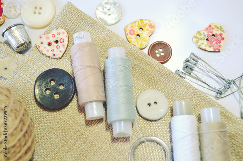 Sewing set of linen fabric, sewing spools, buttons in beige and ecru colours. Scrapbooking and DIY. Hobby and needle work.