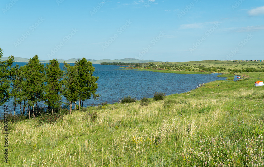 panorama of a beautiful lake with hilly shores. sunny summer day. Lake Shira in Khakassia has mineral, slightly salted water. Lake water has healing properties. 