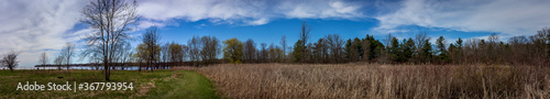Colour panorama landscape photograph taken at Lemoine Point Conservation Area on a clear summer day in Kingston, Ontario Canada.