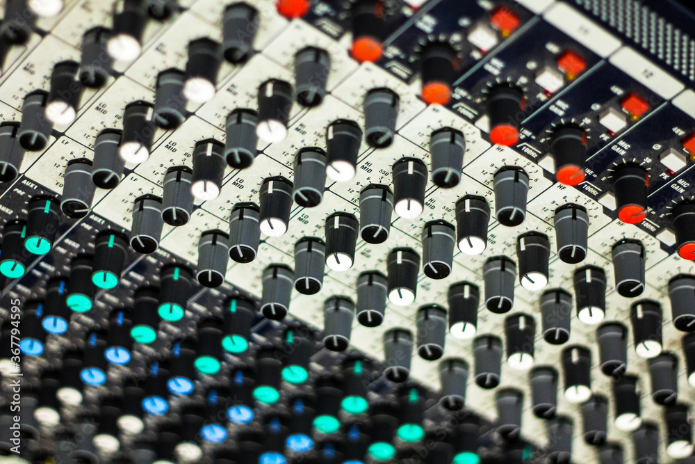 Close up of buttons and tabs of the audio controller in music festival in DJ booth Close up of buttons and tabs of the audio controller in music festival in DJ booth
