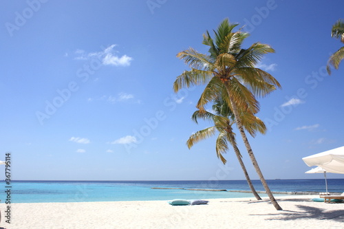 Fototapeta Naklejka Na Ścianę i Meble -  Beautiful paradise beach panorama with white sand, turquoise water sea and cushions and umbrella on the beach, Maldives island.
