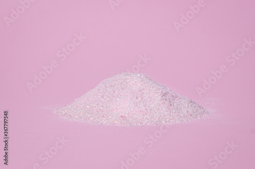 Heap of pink powder on a pink background. Gelatinous dessert mix of pink color, with cherry flavor.