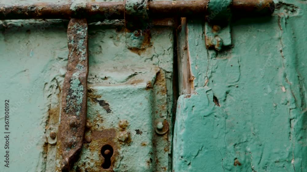 Old, rusty, wooden, mint green door with lock, in Essaouira, Morocco. Close-up vintage footage. Old, rusty, wooden, mint green door with lock, in Essaouira, Morocco. Close-up vintage footage.