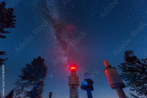 Radio and telecommunication towers of the former NATO listening post on the mountain Hohenbogen near Neukirchen in the Bavarian forest at night with stars and the milky way photo