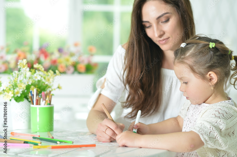 Cute girl with mother drawing at the table Cute girl with mother drawing at the table