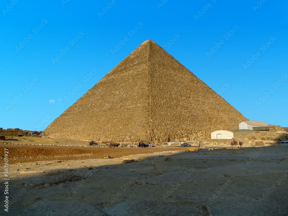 The Great Pyramid at Giza, Egypt illuminated by the late afternoon sun in the summertime The Great Pyramid at Giza, Egypt illuminated by the late afternoon sun in the summertime