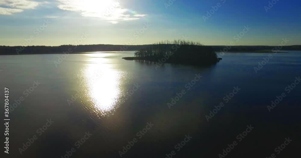 The Sun Reflecting in the lake. A Small Island on the lake. Aerial. 4K The Sun Reflecting in the lake. A Small Island on the lake. Aerial. 4K