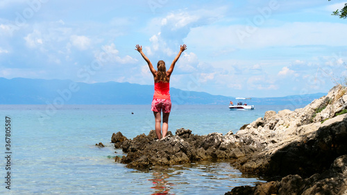 happy woman arms rised on the sea