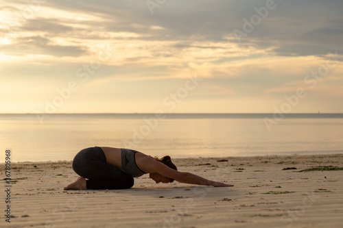 Woman stretching out on the beach