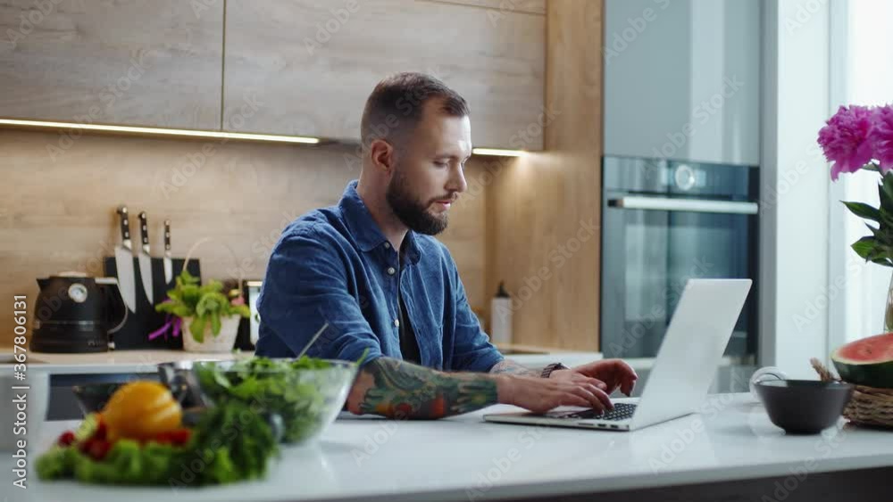 Focused Man Works on a Laptop at Home. Focused Man Works on a Laptop at Home.