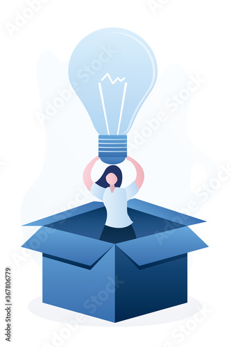 Happy woman in an opened cardboard box. Successful businesswoman holds idea bulb. Creative person or developer