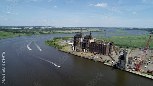 Aerial view of Jet skiers in front of old coal power plant being dismantled in Sayreville  NJ