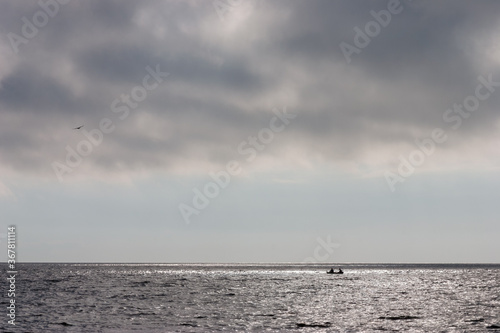 Two in a boat at the sea horizon