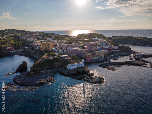 Panoramic aerial view at sunset of the roman harbour and of the colorful village of Ventotene island
