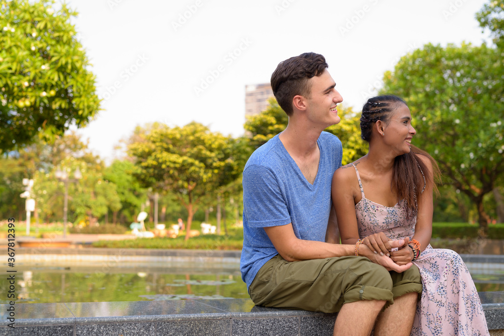 Portrait of young multi ethnic couple relaxing together at the park Portrait of young multi ethnic couple relaxing together at the park